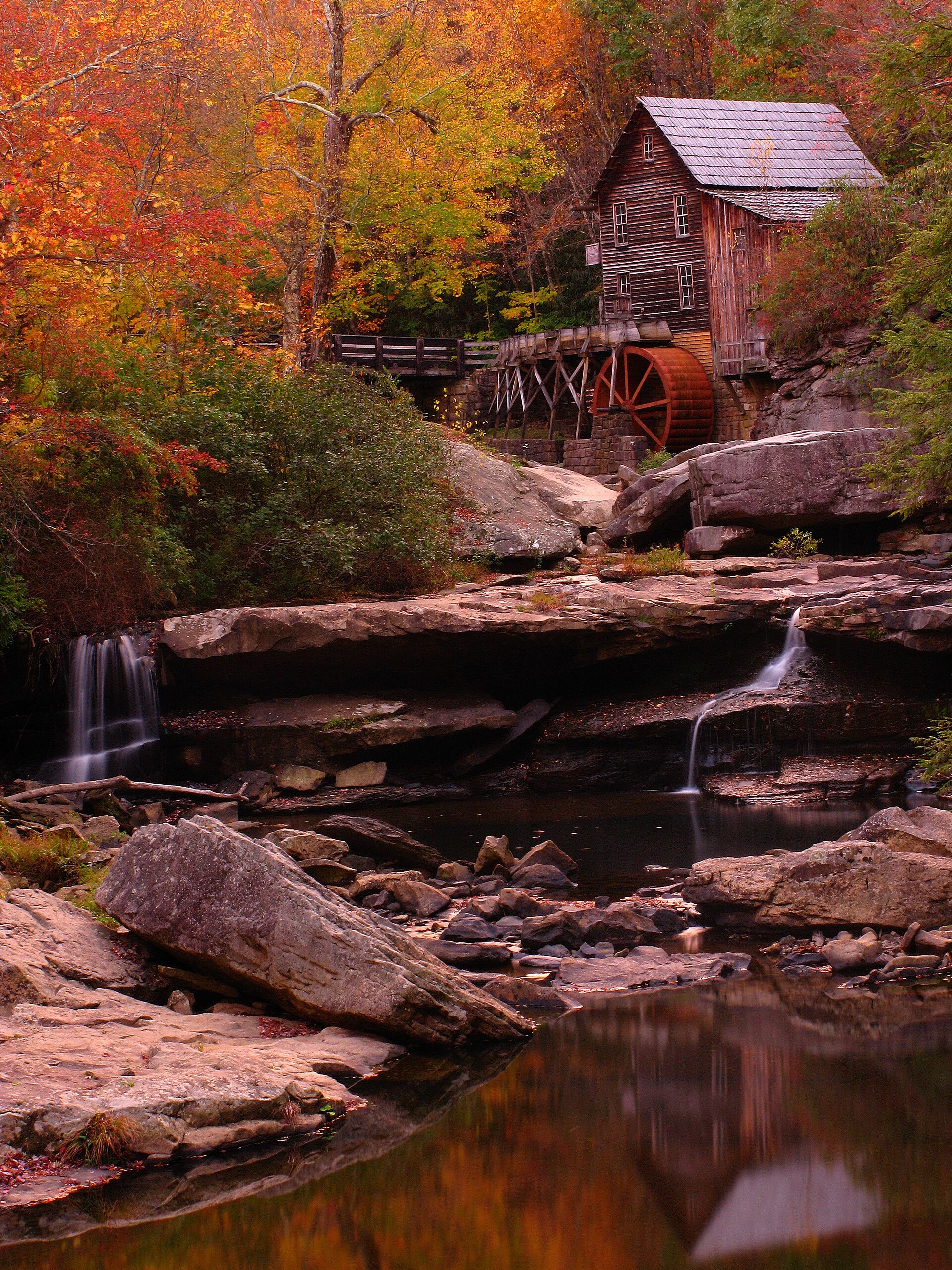 The historic Glade Creek Grist Mill amid autumn foliage in the West Virginia hills
